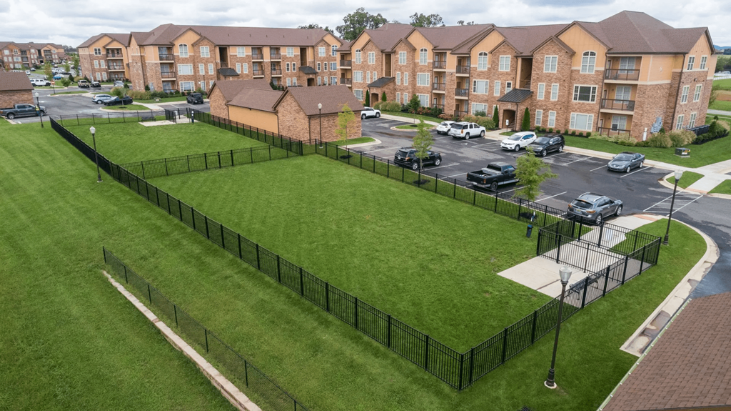 A large grassy area in front of apartment buildings.
