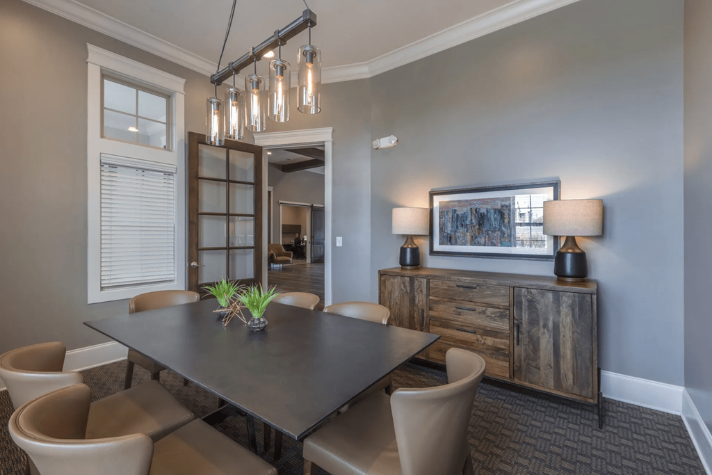 A conference room with a table, chairs, and a chandelier.