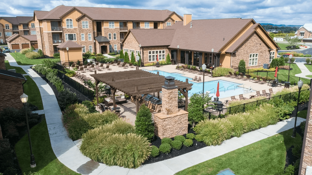 A large building with a pool in front of it.