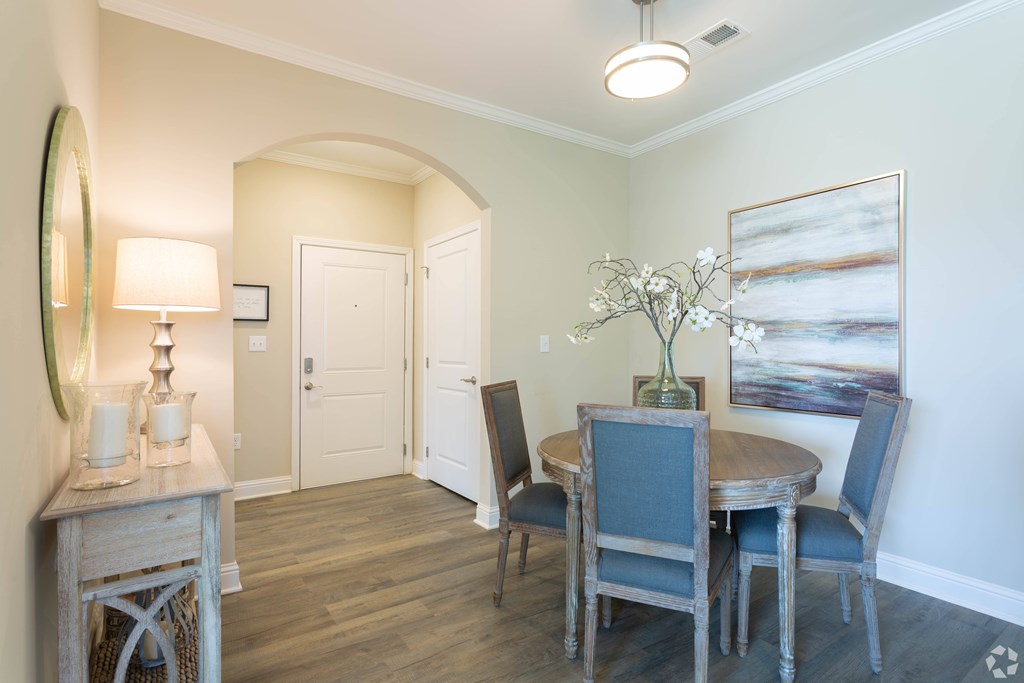 A dining room with a wooden table and chairs.
