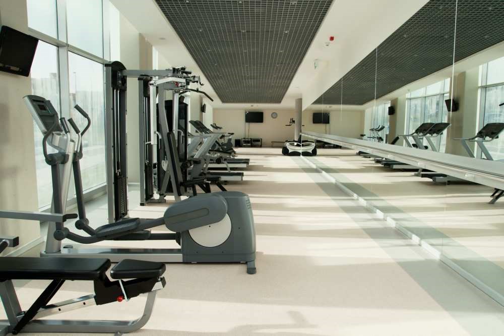 A gym with treadmills, elliptical machines, and other cardio equipment.