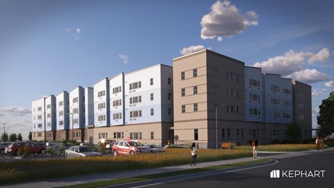 A modern apartment building complex with cars parked in front.