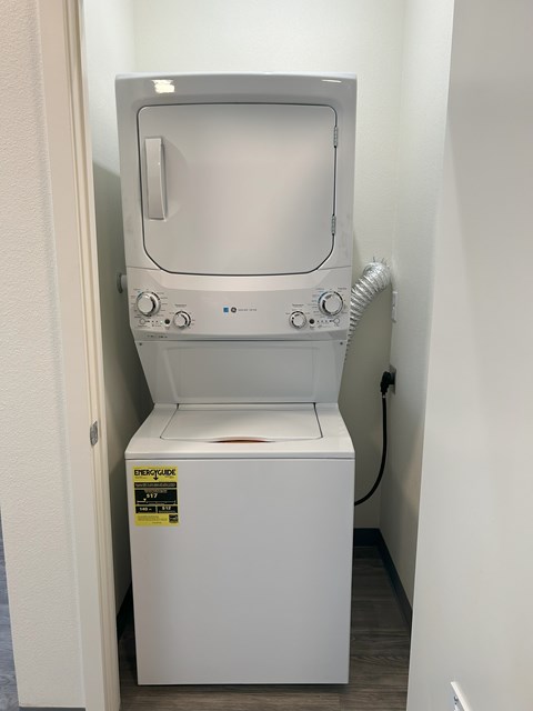 A white dryer is sitting in a small room.