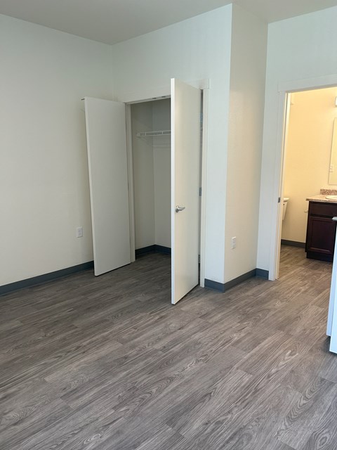 A room with a wooden floor and a white door.
