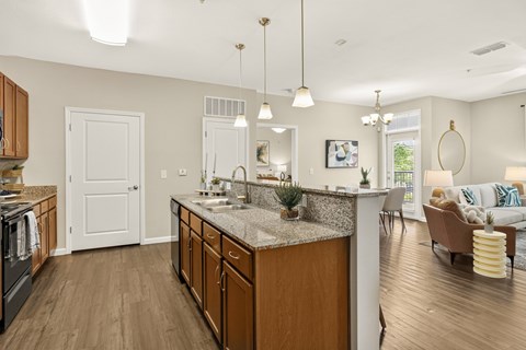 A kitchen with wooden cabinets and a granite countertop.