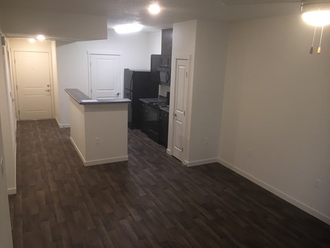 A kitchen area with a refrigerator and a counter.