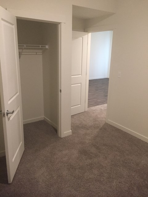 bedroom with a door open to hallway.