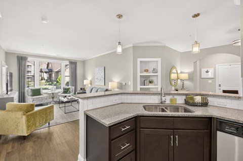 A modern kitchen with a yellow chair and a large window.