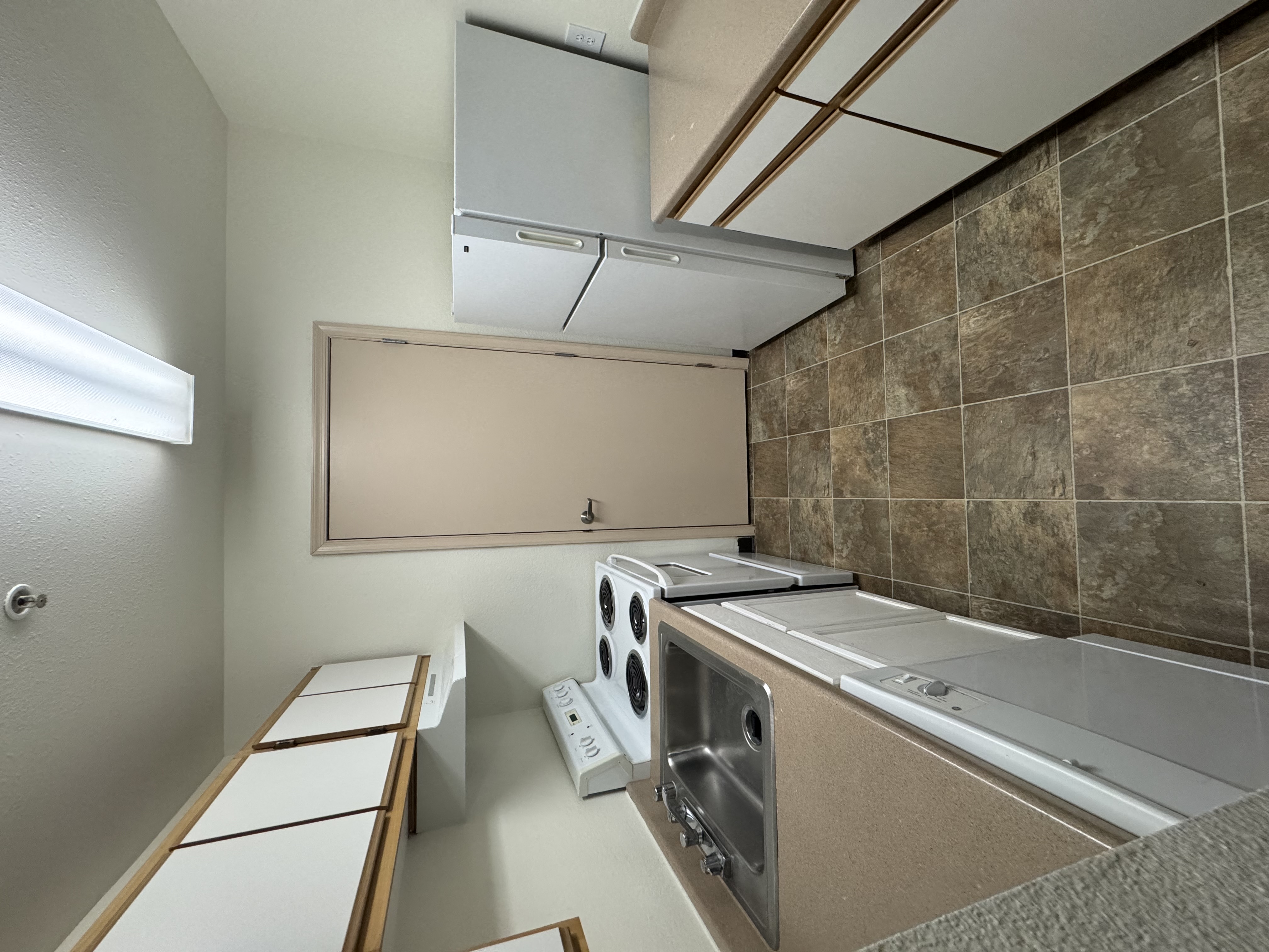 A kitchen with a washing machine and a dishwasher.