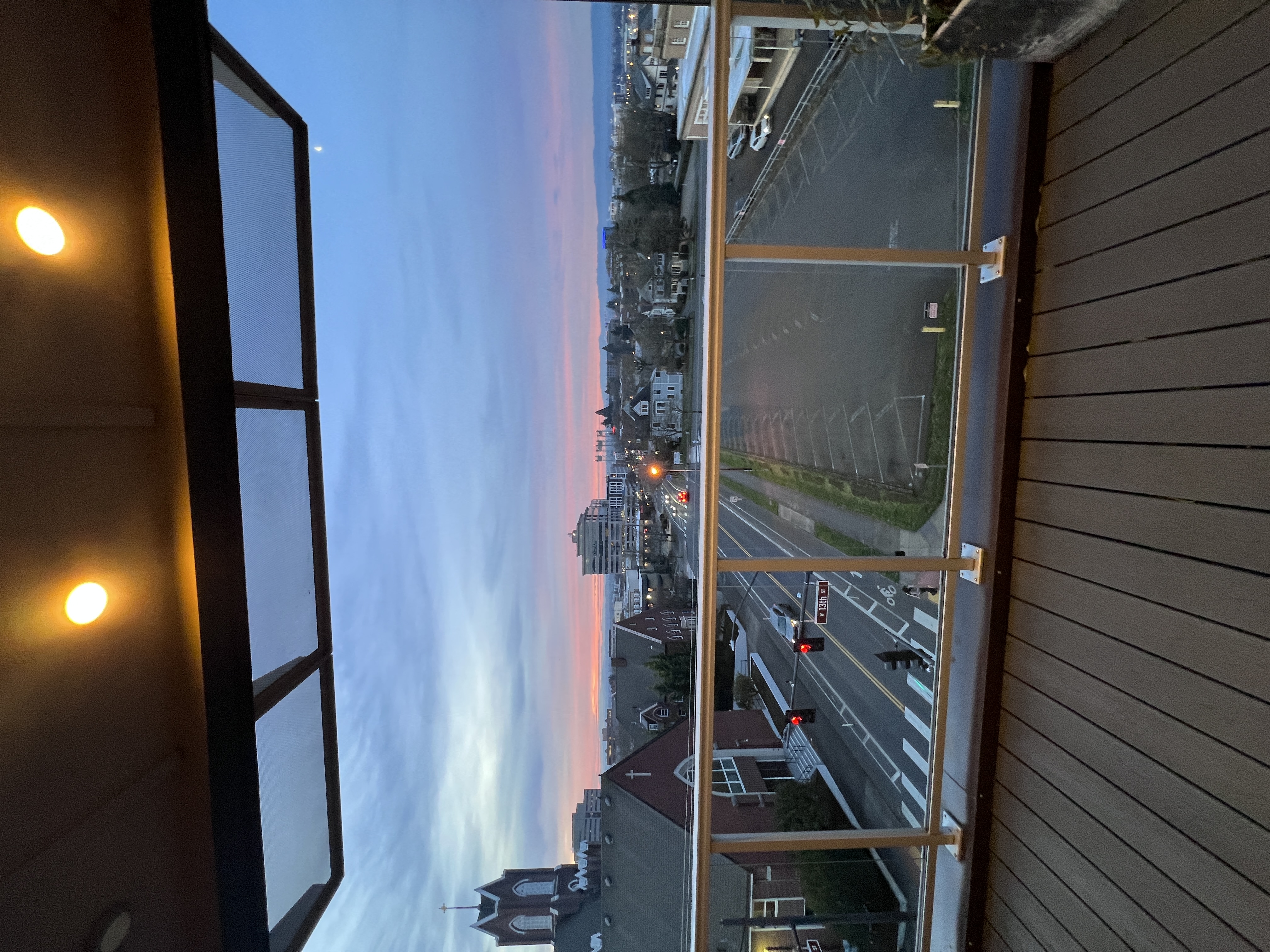 A view from a window looking out at a city street.