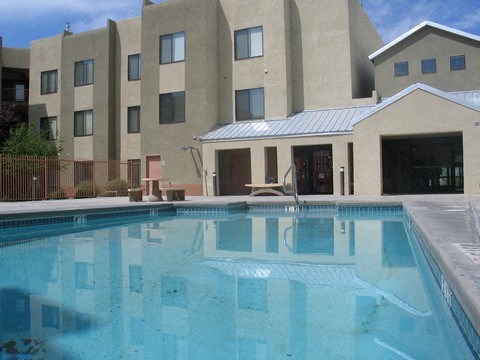 A swimming pool in front of a building.