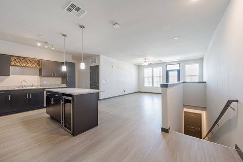 A spacious kitchen with dark wood cabinets and a central island.