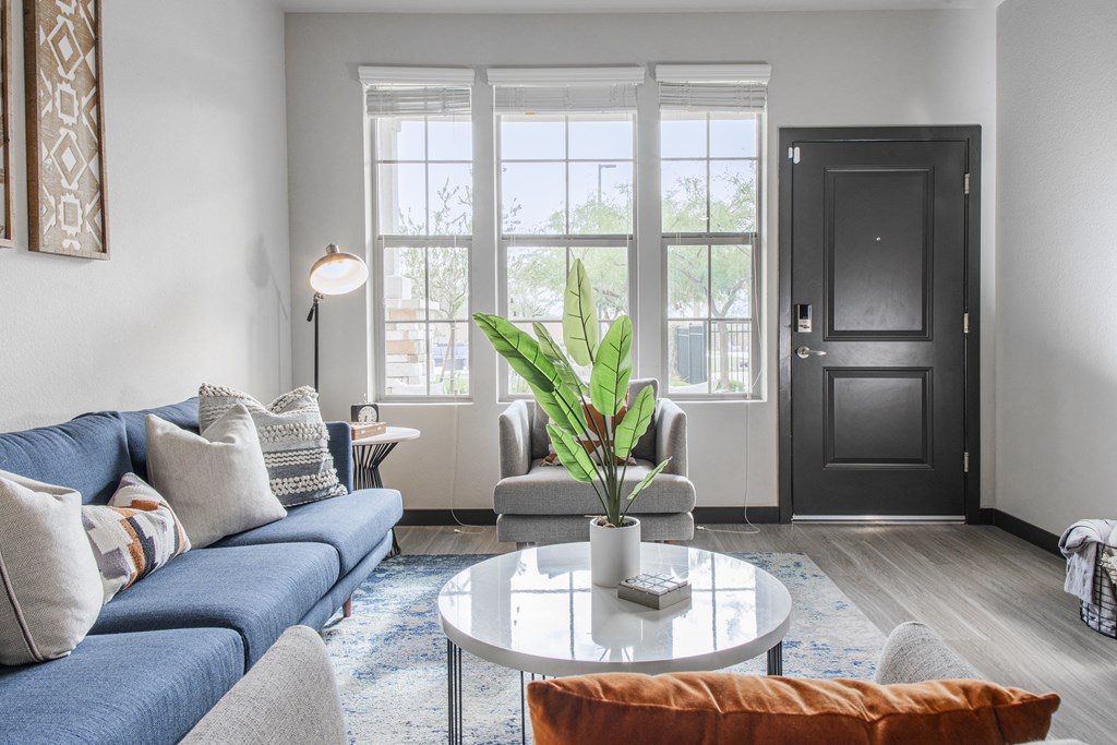 a living room with a blue couch and a coffee table