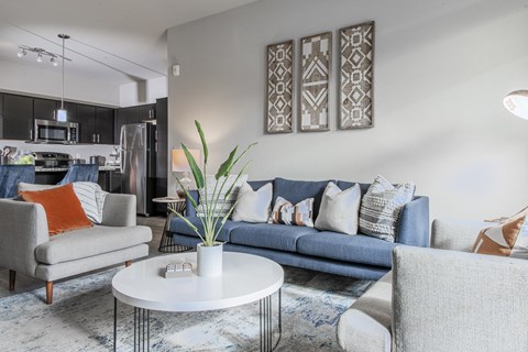 a living room with couches and chairs and a coffee table