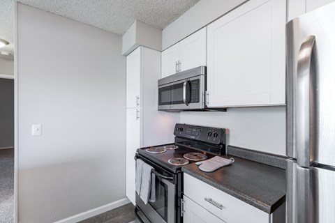 a kitchen with stainless steel appliances and white cabinets