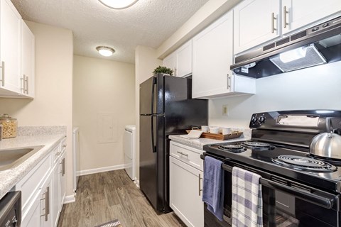 a kitchen with a stove refrigerator and sink