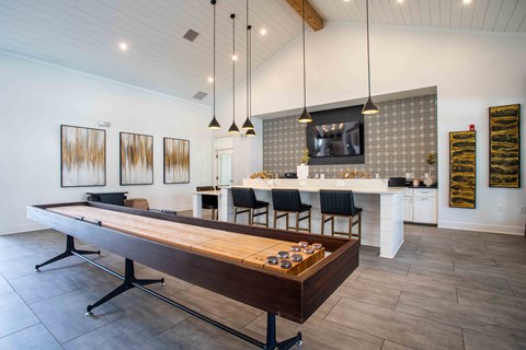 a game room with a pool table and sitting area
