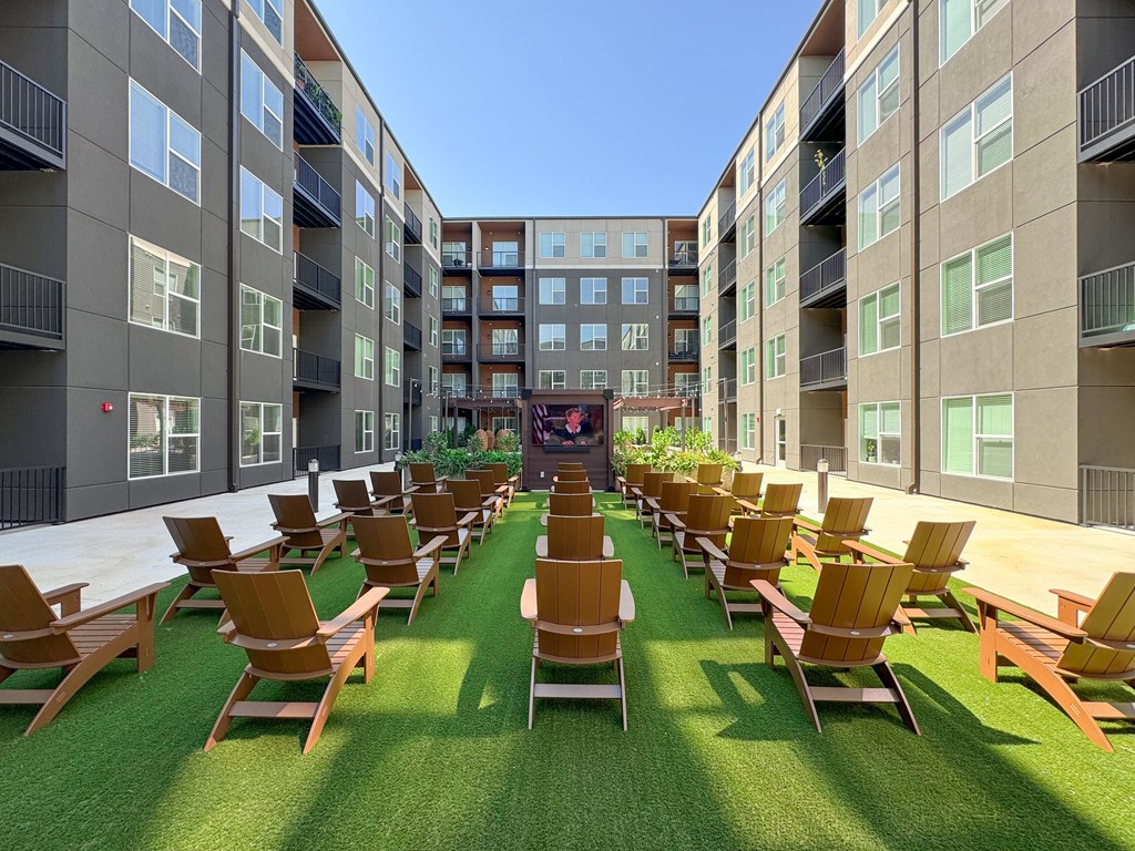 A sunny day at the outdoor seating area of a modern apartment complex.