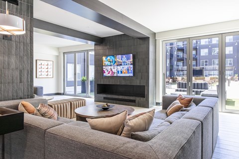 A living room with a grey couch and a television.
