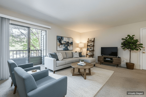 A living room with a grey couch, a white sofa, a wooden coffee table, and a television.