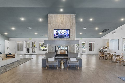 A modern living room with a television mounted on the wall.