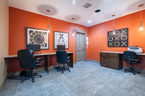 a conference room with three desks and chairs and a door