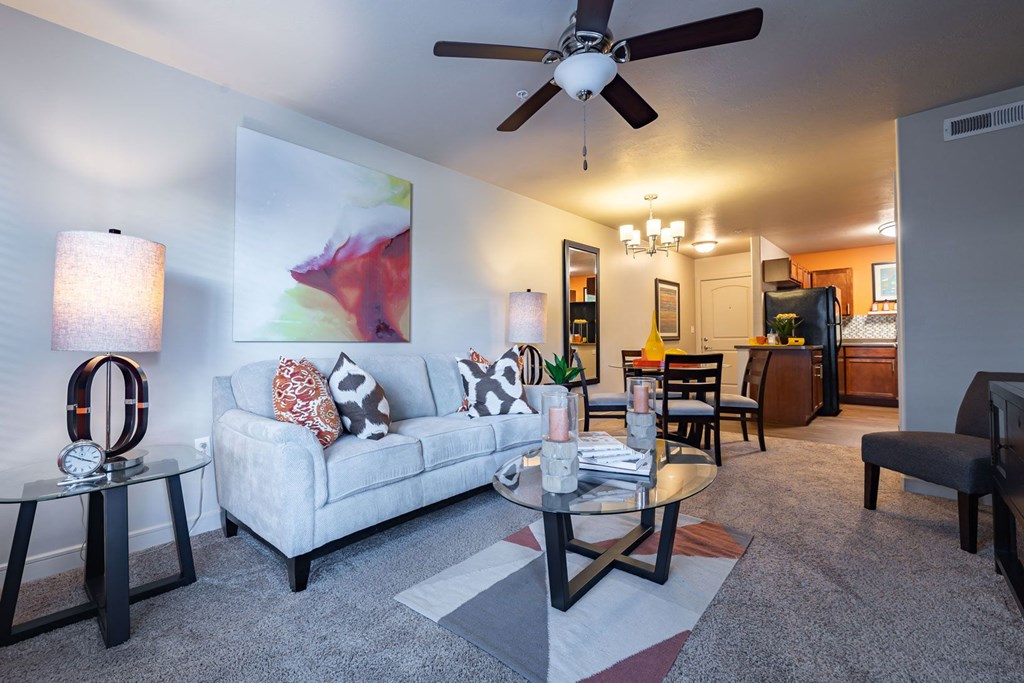 a living room with a couch and a ceiling fan