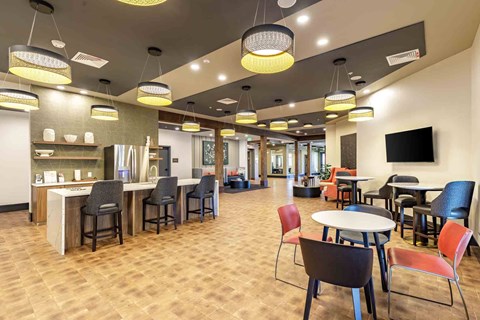 Clubhouse lounge area with a variety of chairs and tables.