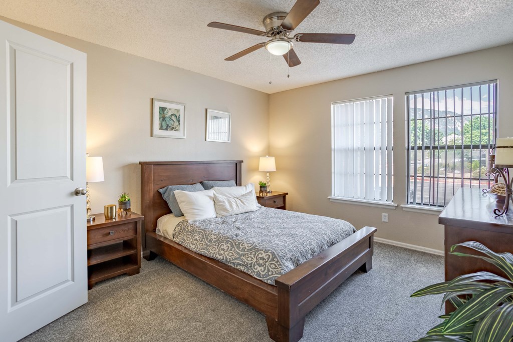 a bedroom with a bed and a ceiling fan
