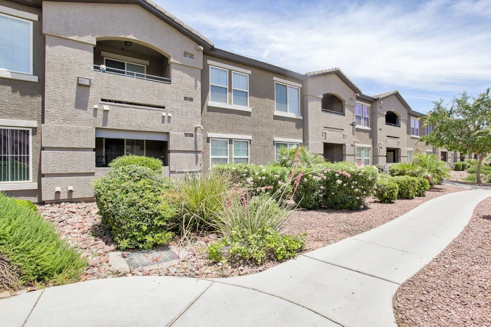 a sidewalk in front of an apartment building