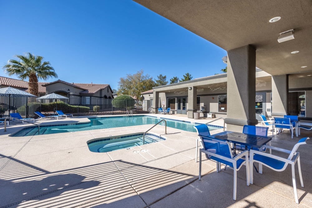our apartments have a pool and patio with chairs and tables