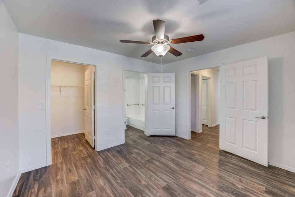 Bedroom with a ceiling fan and a closet