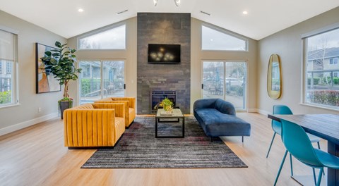 a living room with yellow furniture and a fireplace