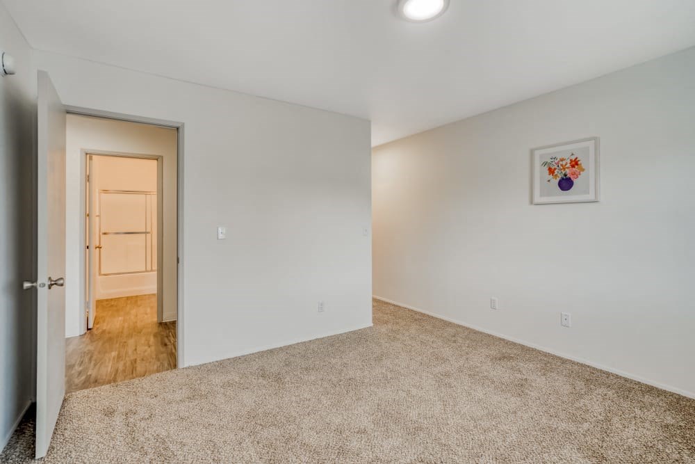 a bedroom with a door to a hallway