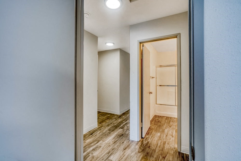 Hallway with a door to a closet and bathroom