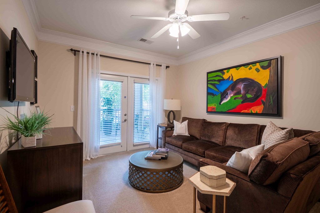 a living room with a couch and a ceiling fan