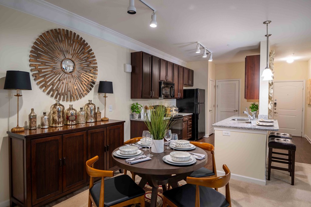 a kitchen and dining room with a table and chairs