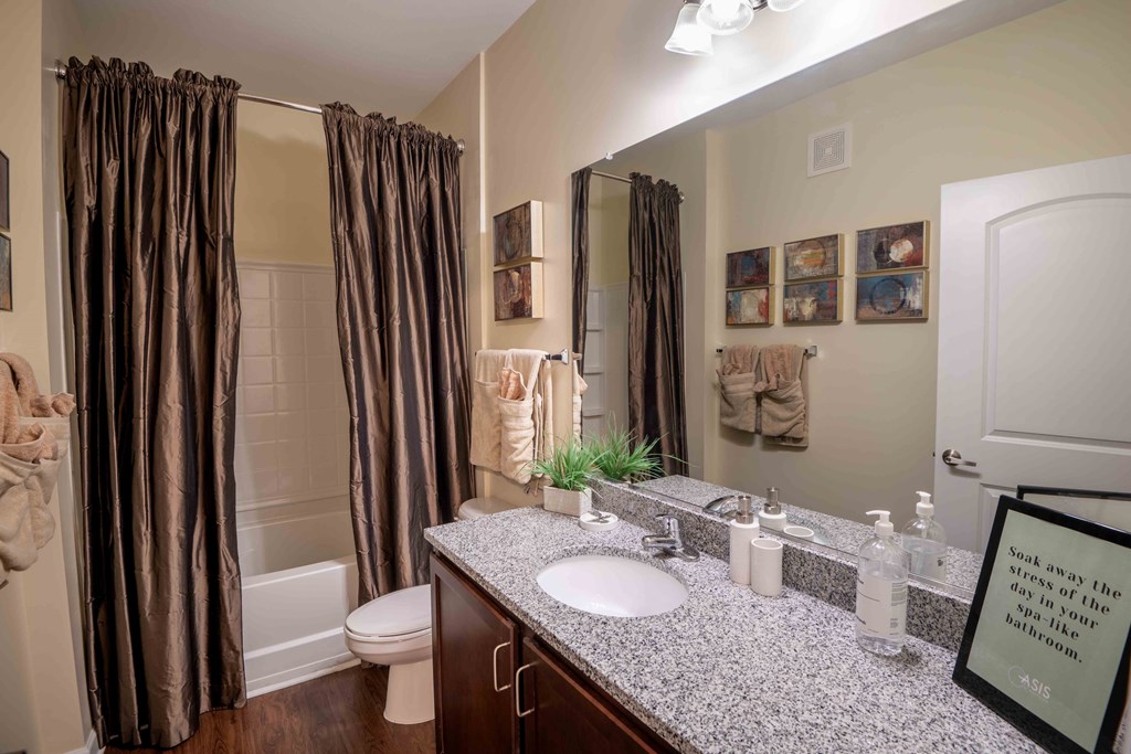 a bathroom with a sink and a shower and a toilet