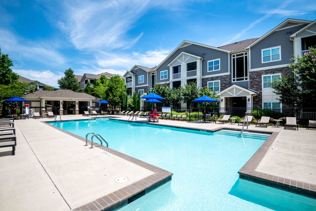 a swimming pool with a building in the background
