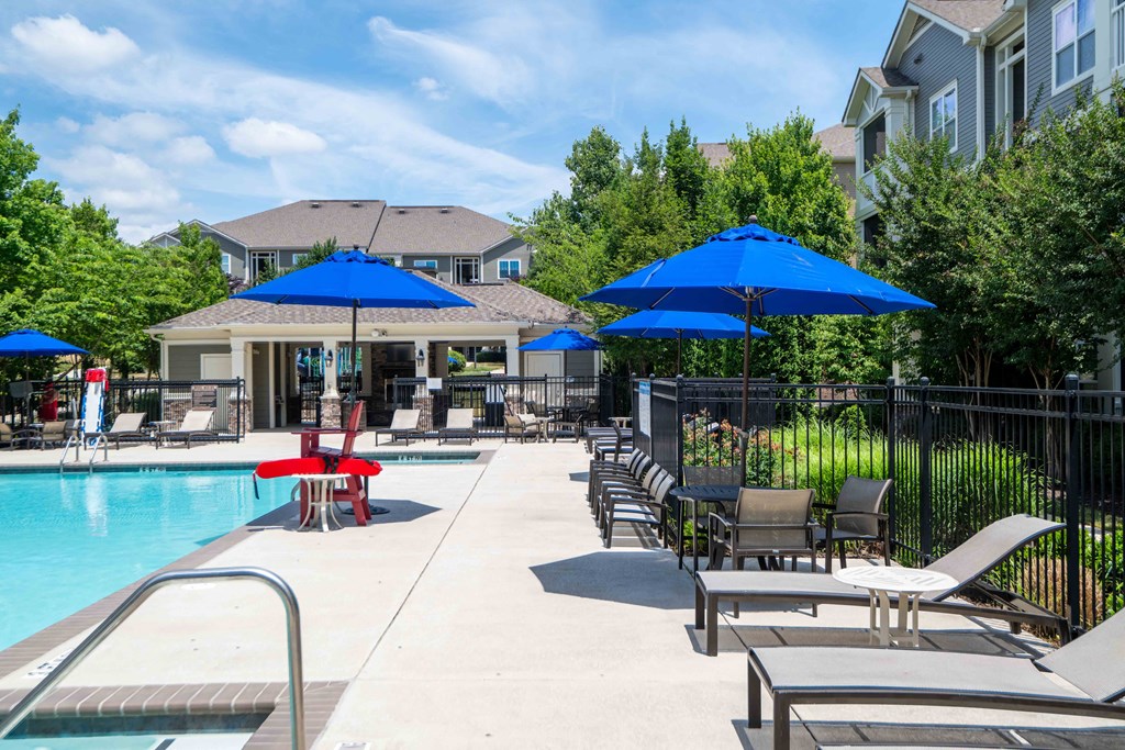 our apartments have a pool and patio area with umbrellas
