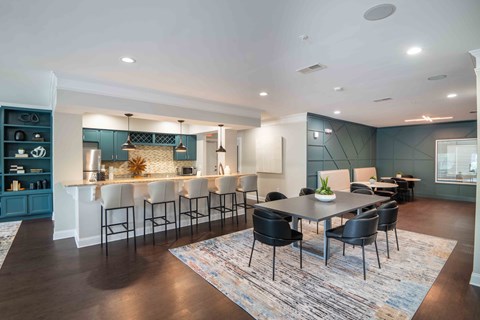 a kitchen and dining room with a table and chairs