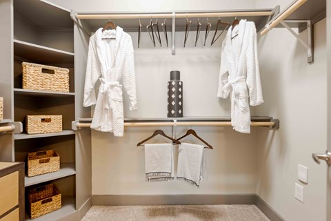 A bathroom with a towel rack and a towel hanging on it.