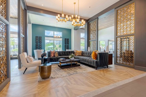 A modern living room with a grey sofa and a wooden coffee table.