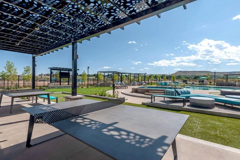 A shaded picnic area with ping pong