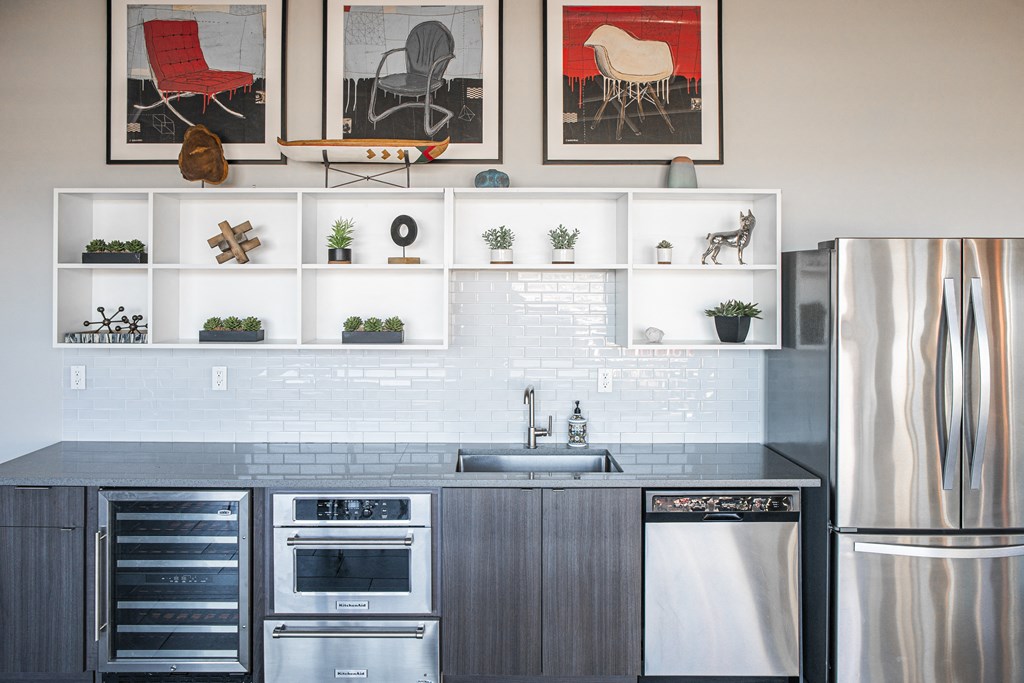 a kitchen with white cabinets and a stainless steel refrigerator