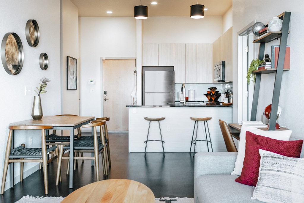 a living area with a kitchen and a dining table