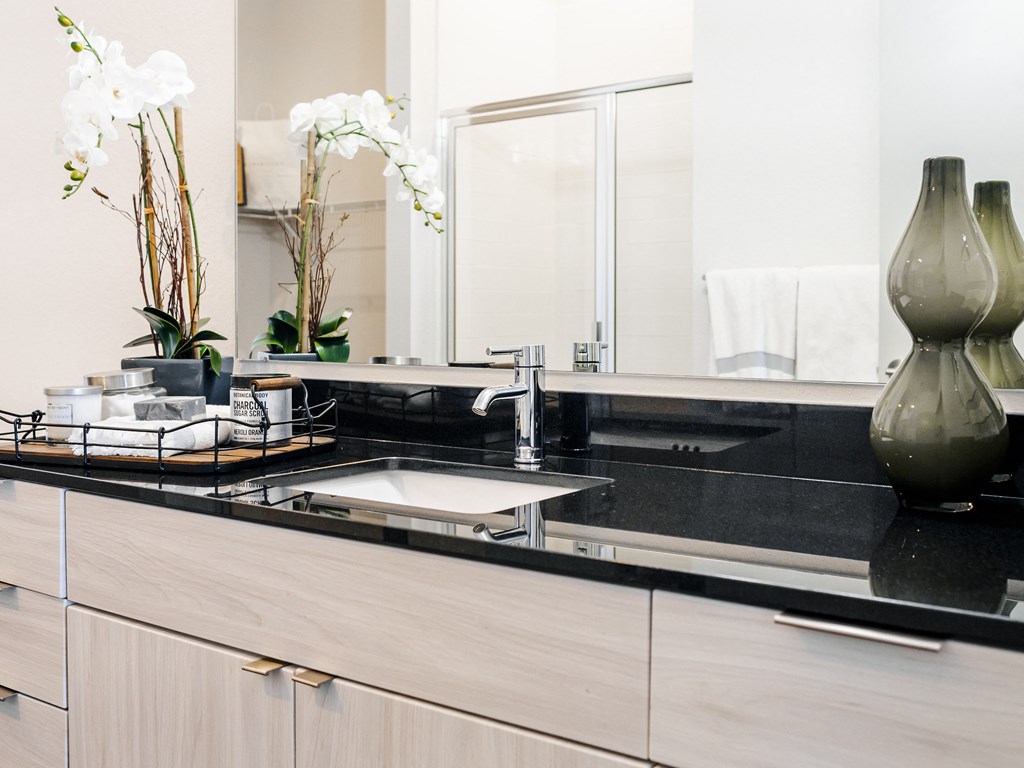 a modern bathroom with a sink and a mirror