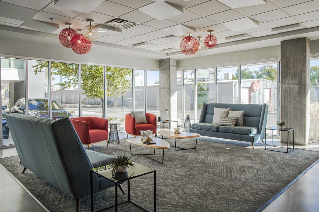 a lobby with couches and chairs and a rug