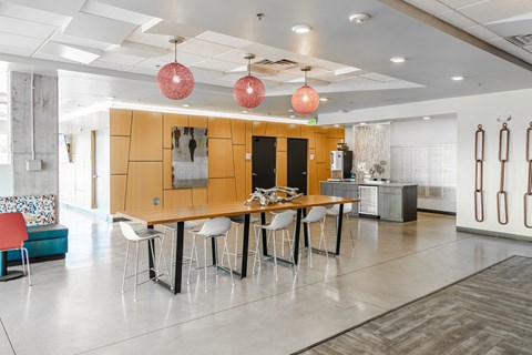a dining room with a table and chairs in front of a kitchen