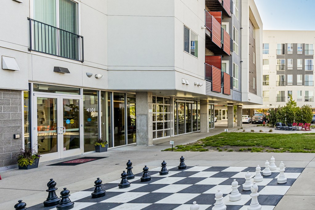 a large chess board in front of a building